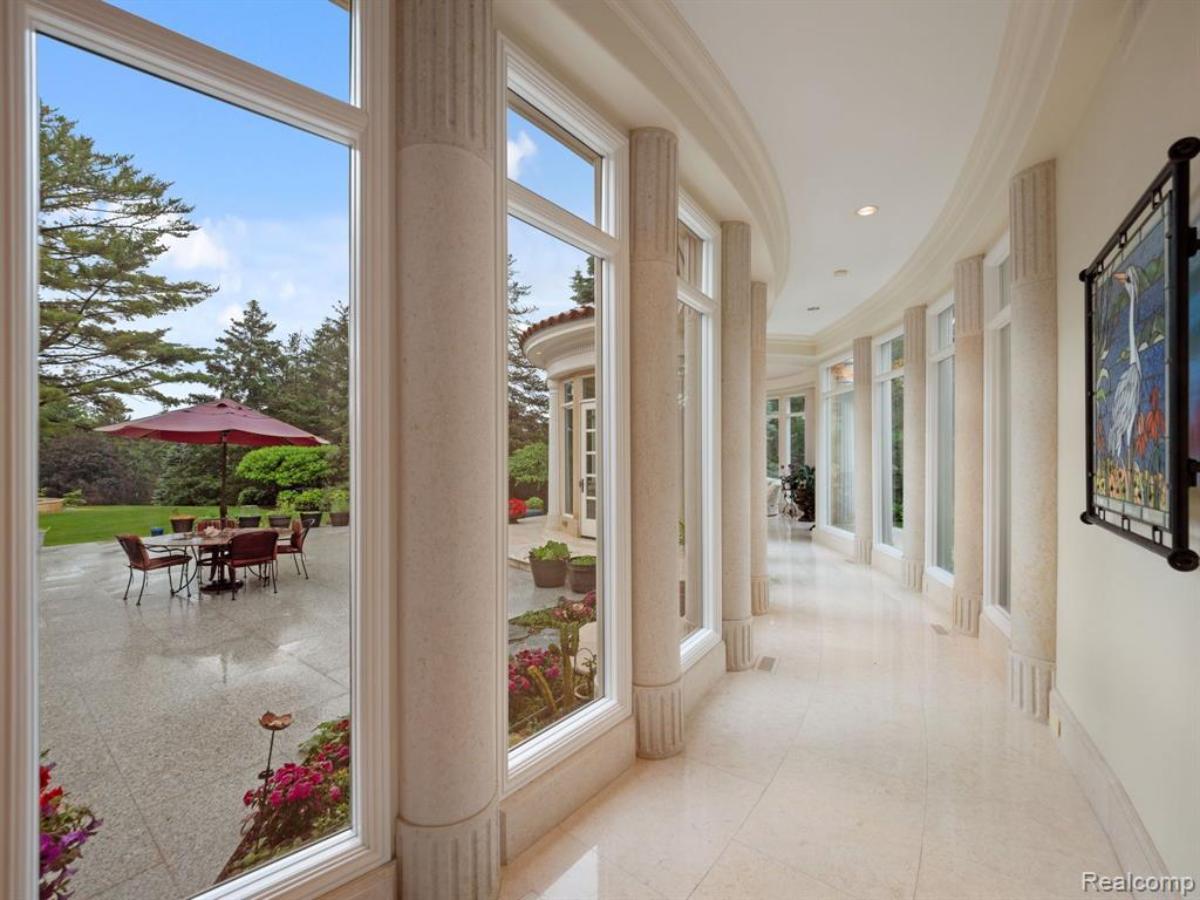 Hallway with tile flooring and glass walls.