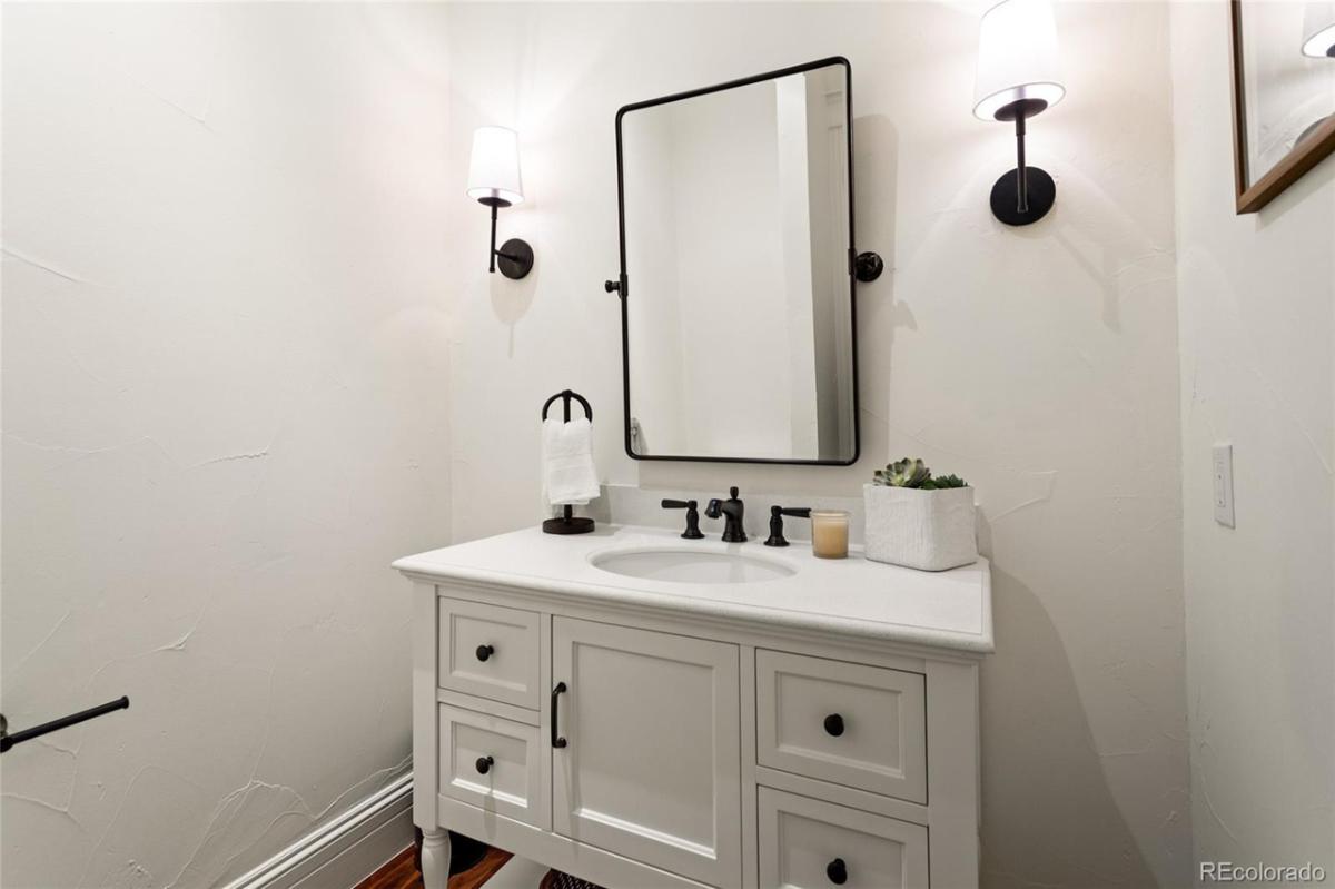 Bathroom with a white vanity and mirror.