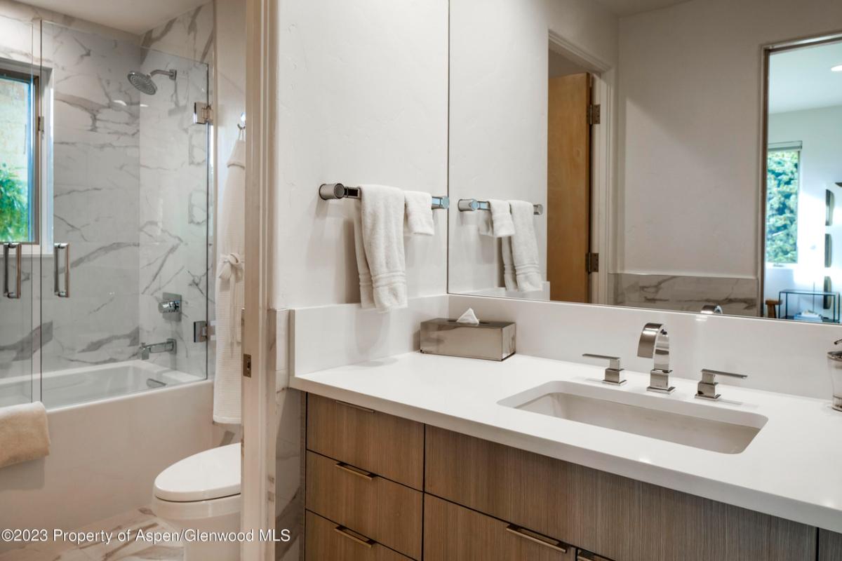 Bathroom with a sink, toilet, soaking tub and a walk-in shower.
