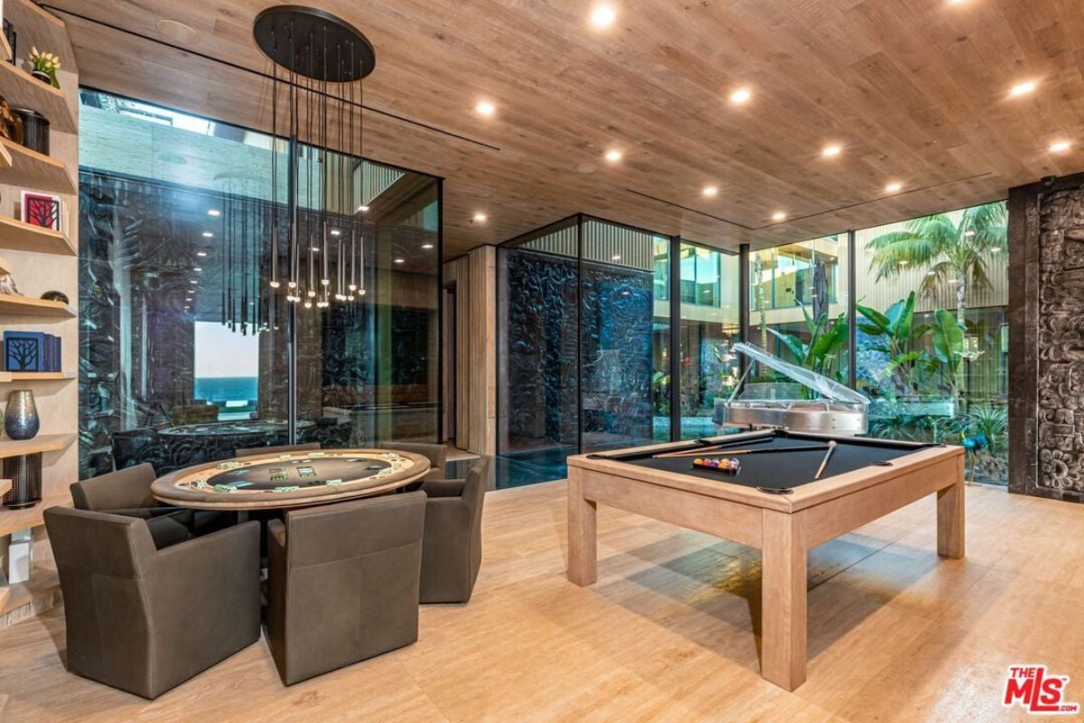 A game room with a billiard table and a poker table.