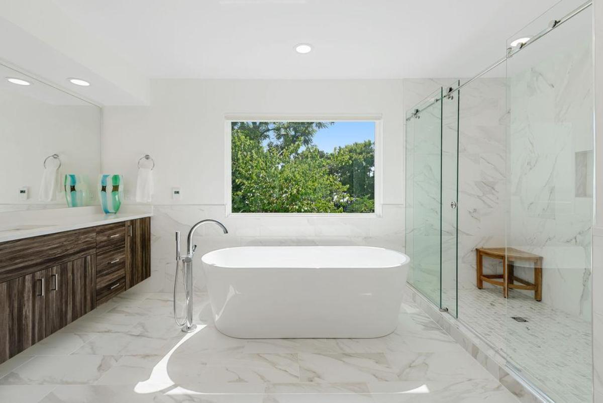 Bathroom with a sink, soaking tub and a shower.