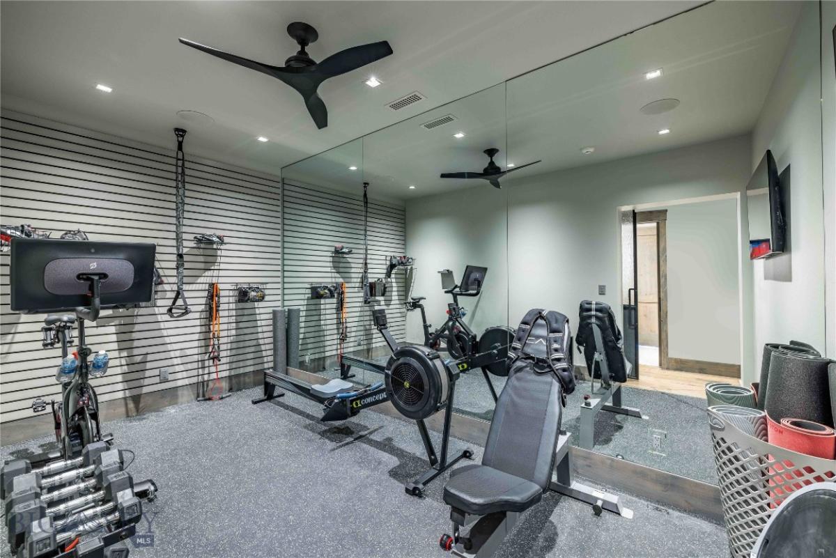 Home gym with a large mirror.