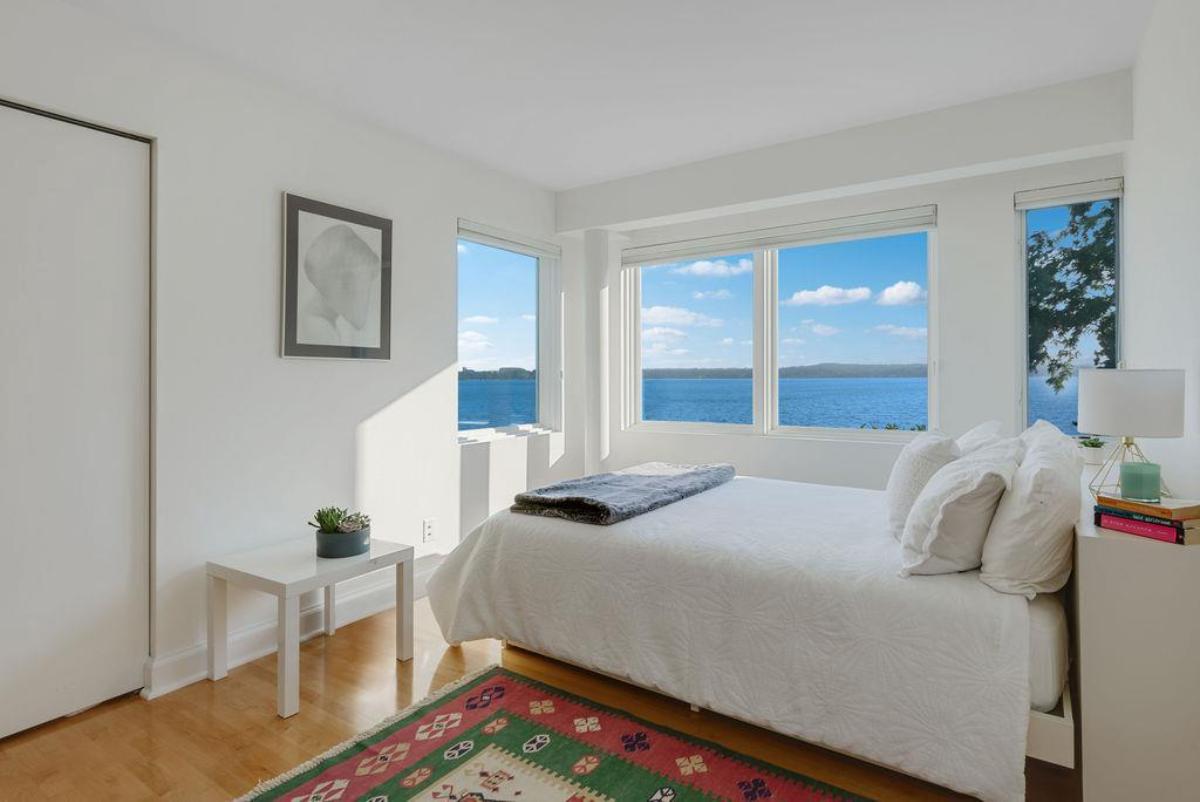 Bedroom with wood flooring and glass windows.