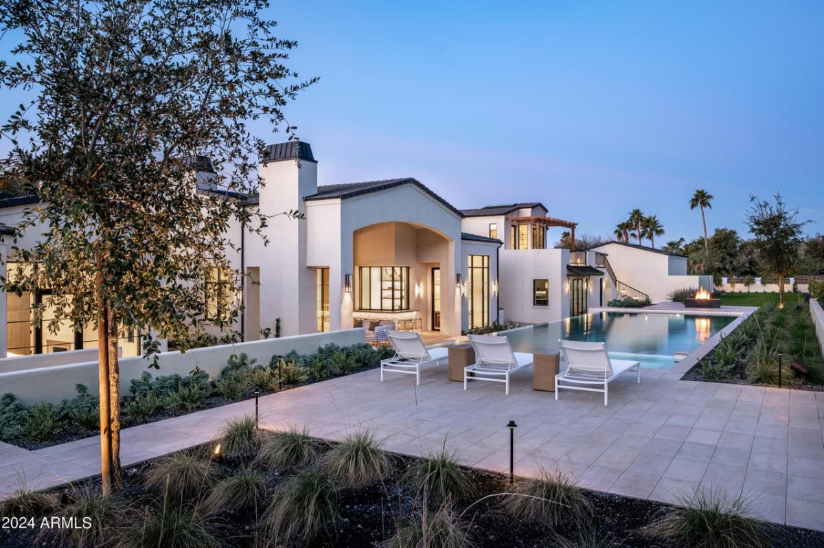 Exterior view of the mansion with a pool.