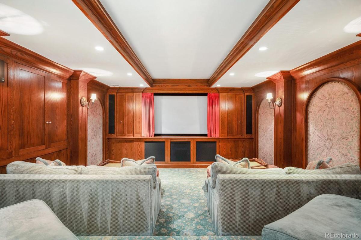 Home theater with a large screen and custom lights.