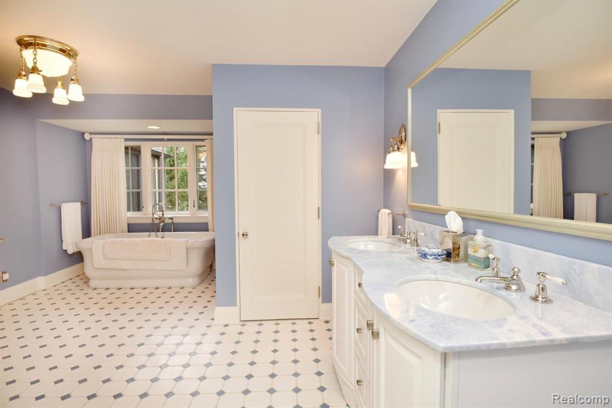 Bathroom with sink, mirror and a soaking tub.
