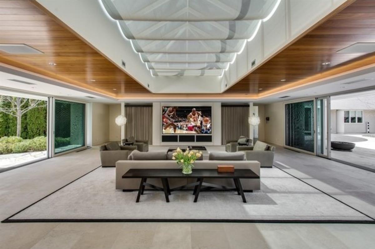 Living room with couches and large sliding glass doors.