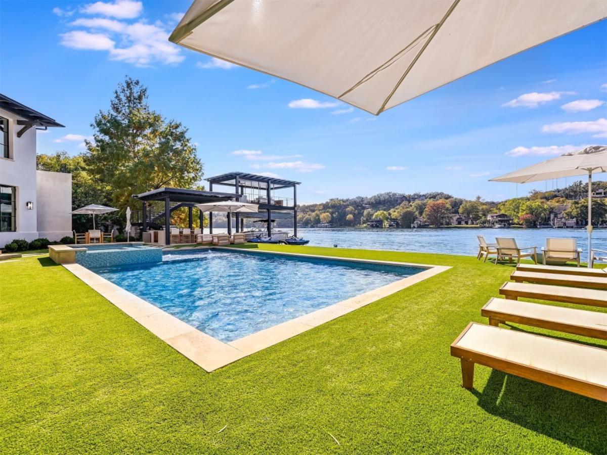 Pool with lounge chairs and a view of the lake.