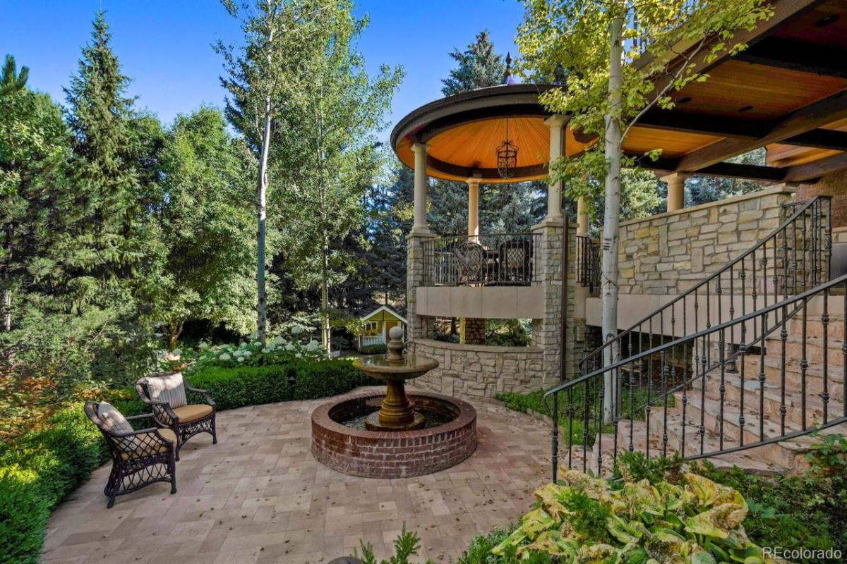 Patio with chairs and a fire pit.
