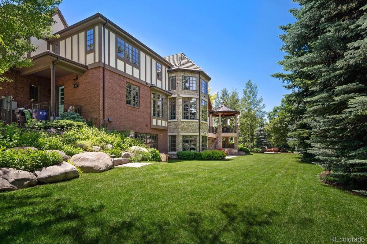 Backyard with a large green lawn.