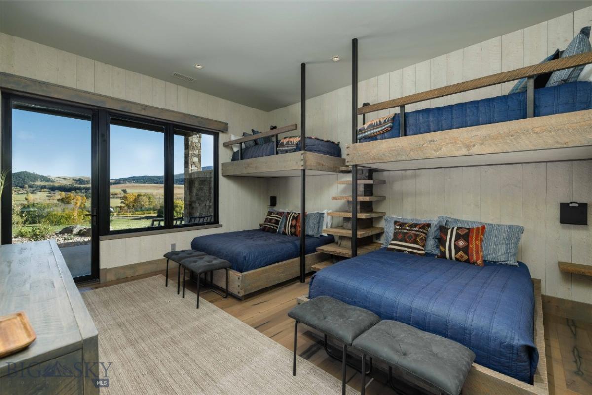 Bedroom with bunks and wood flooring.