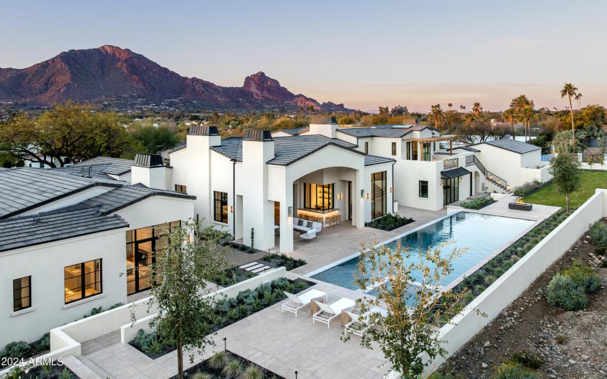 Aerial rear view of the mansion with a pool.