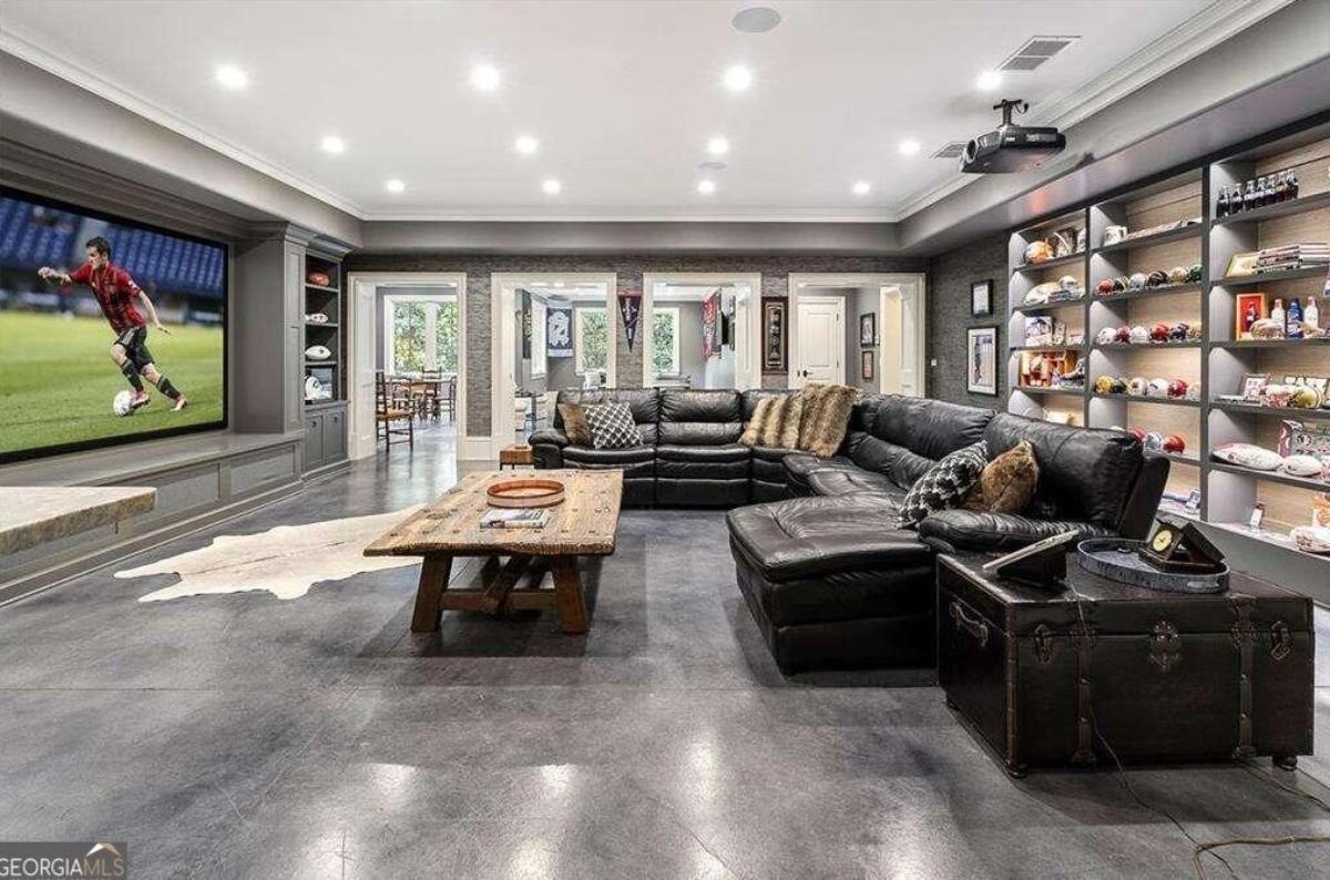 Recreational room with a large TV and couches.