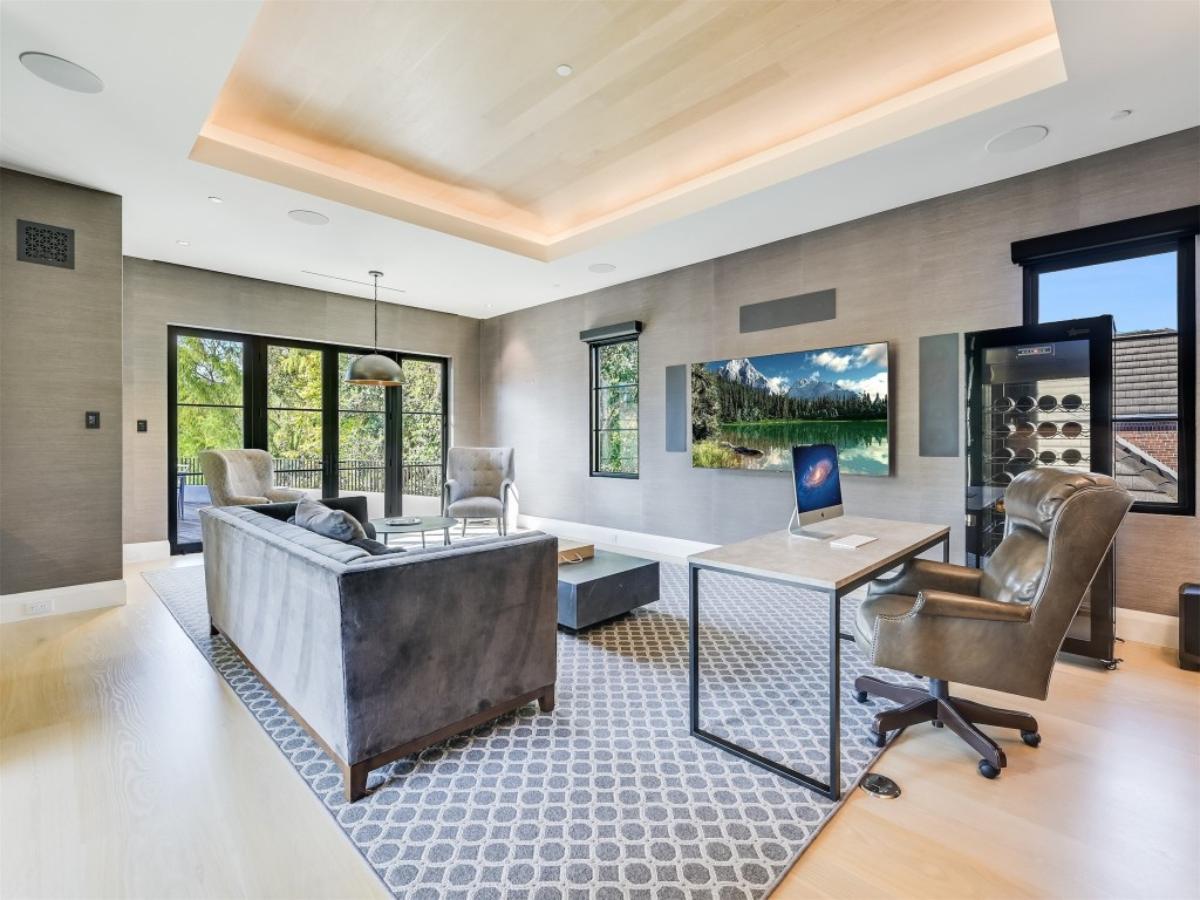 Home office with a desk, couch and a chair.