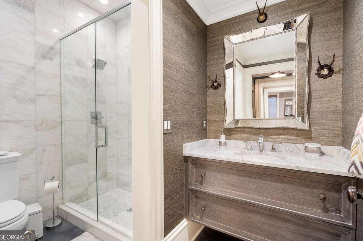 Bathroom with sink, toilet and a walk-in shower.