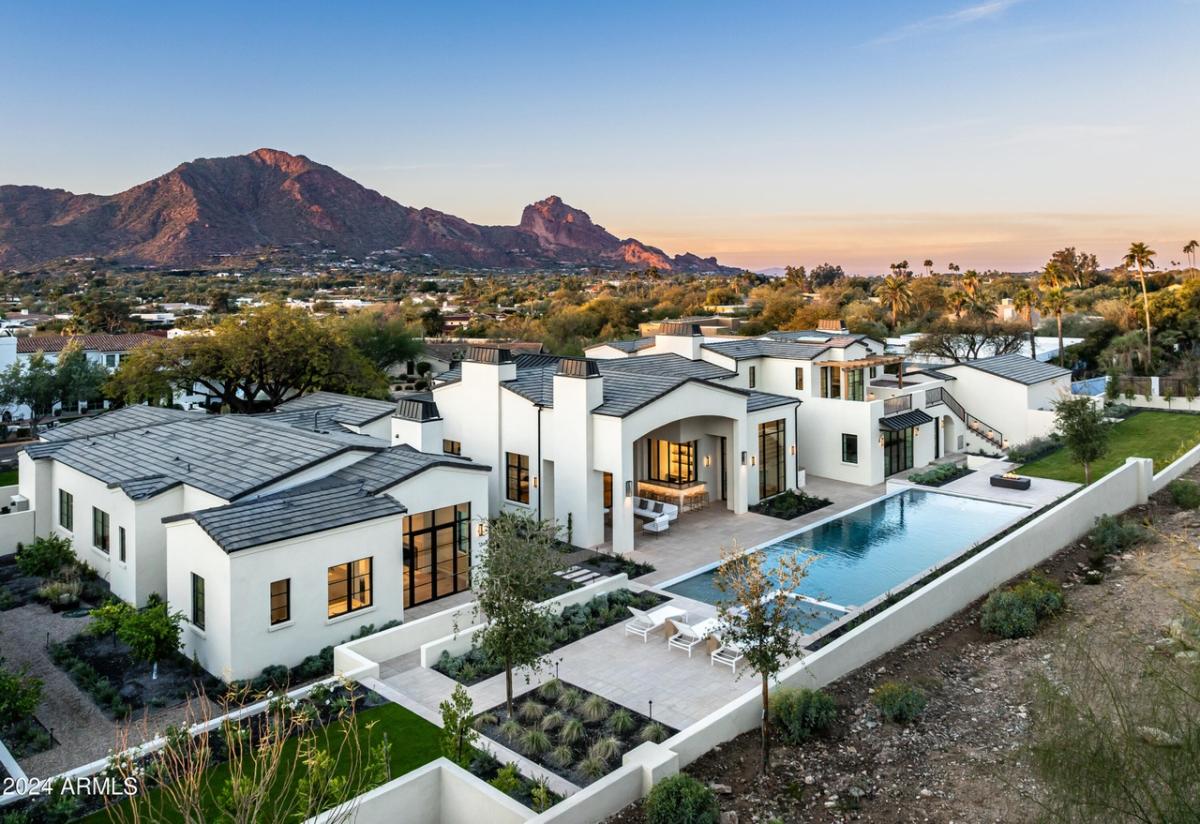 Aerial rear view of the mansion with a pool,
