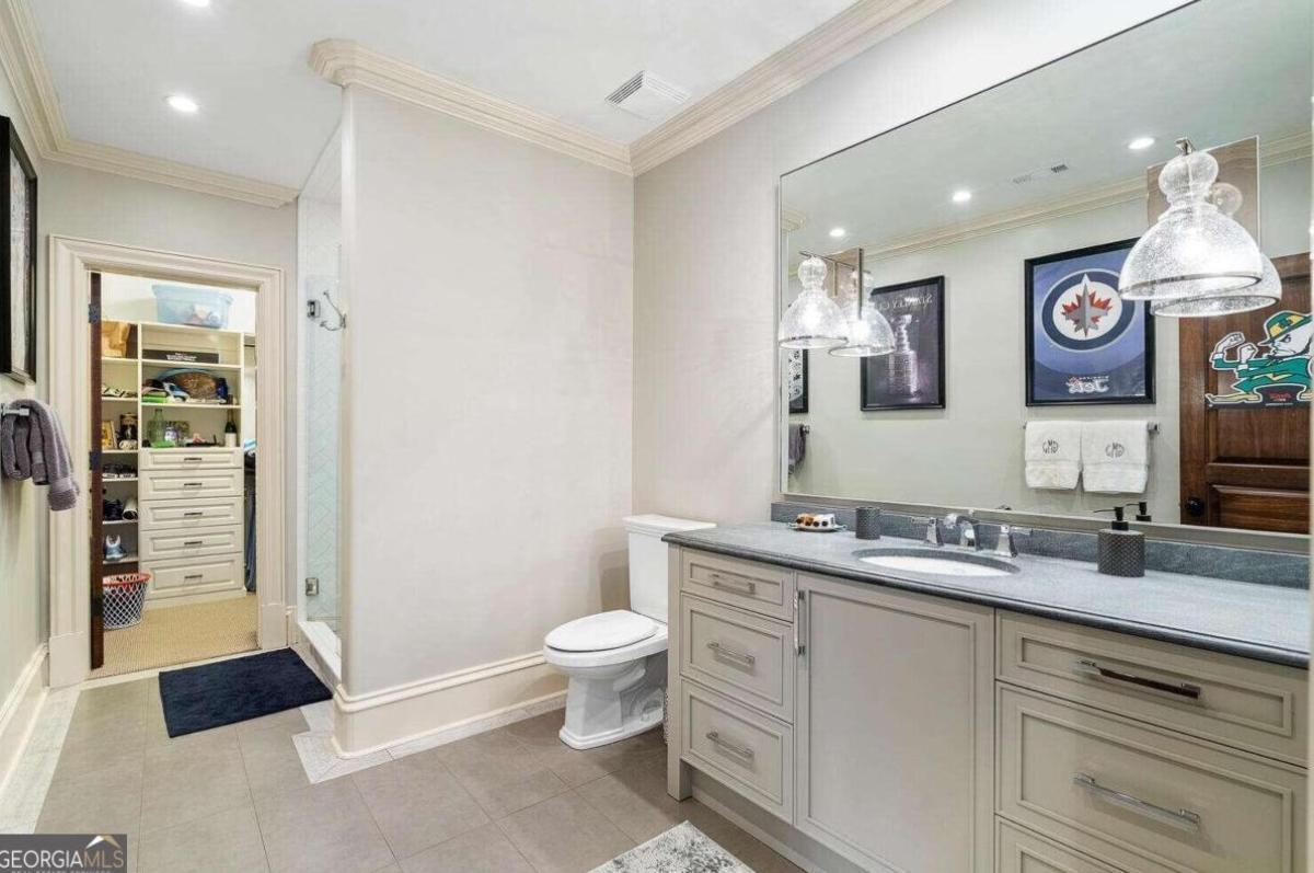 Bathroom with a shower, sink and toilet.
