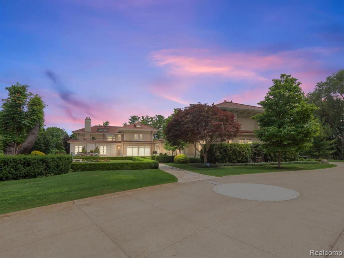 Exterior view of the mansion with a spacious driveway.