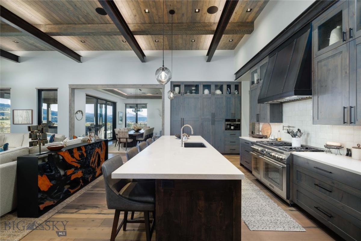 Kitchen with a large island, custom cabinets and cooking area.