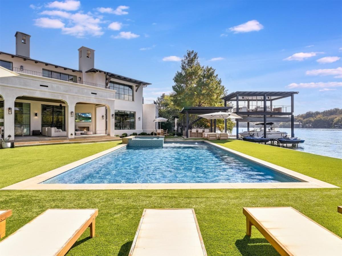 Backyard with a swimming pool and lounge chairs.