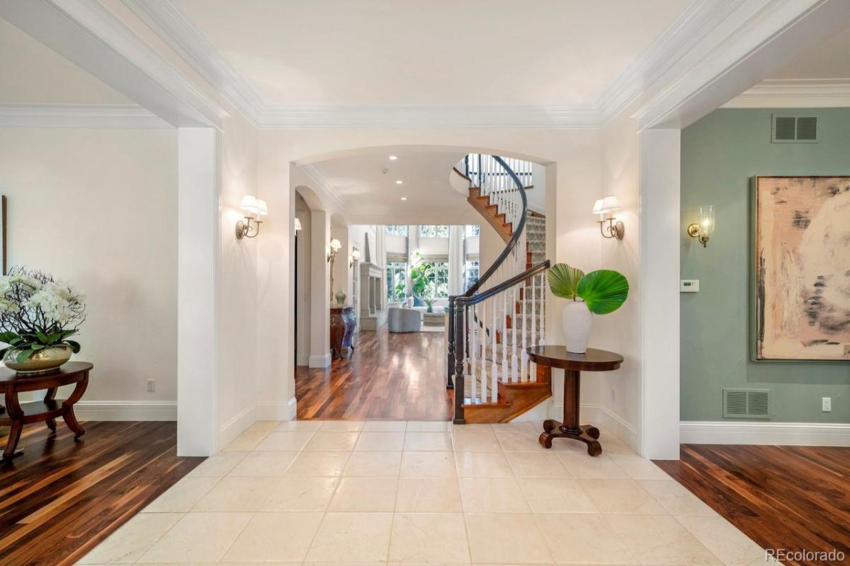 Foyer with a staircase and custom lights.