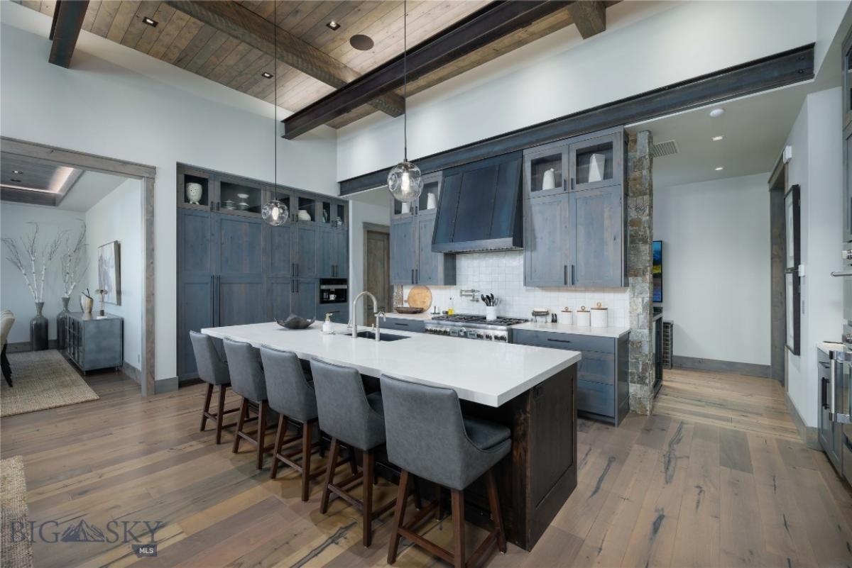 Kitchen with a large island, custom cabinets and cooking area.