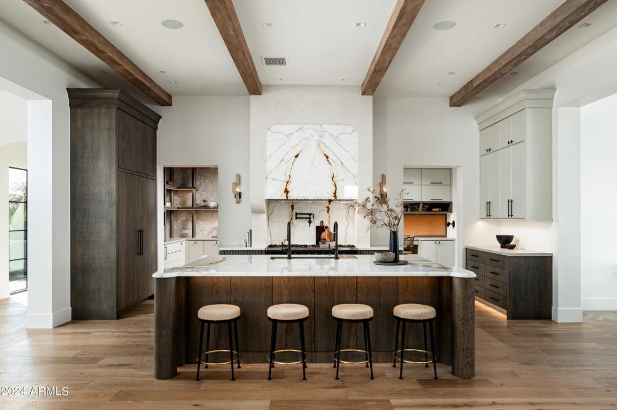 Kitchen with a large island and wood flooring.