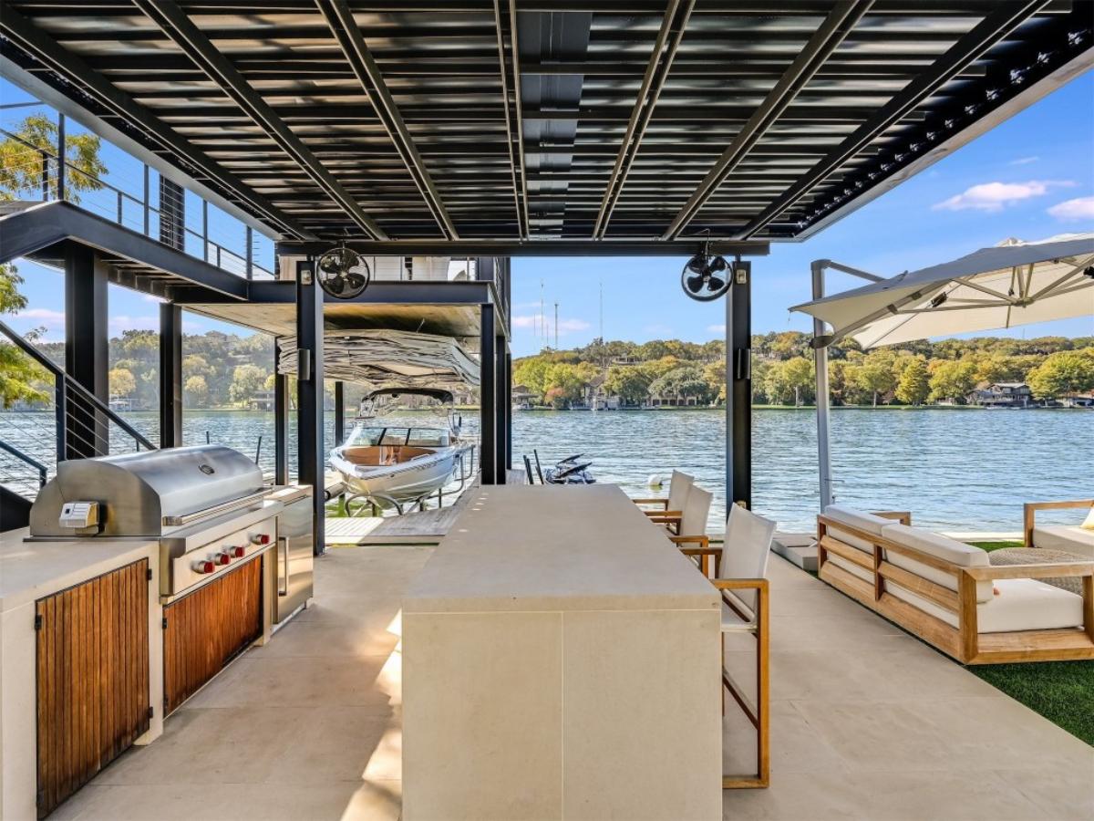Boat dock with a grill, table and chairs.