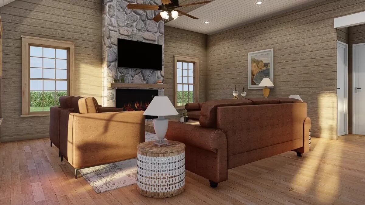 Great room with brown sofas and a stone fireplace topped with a TV.