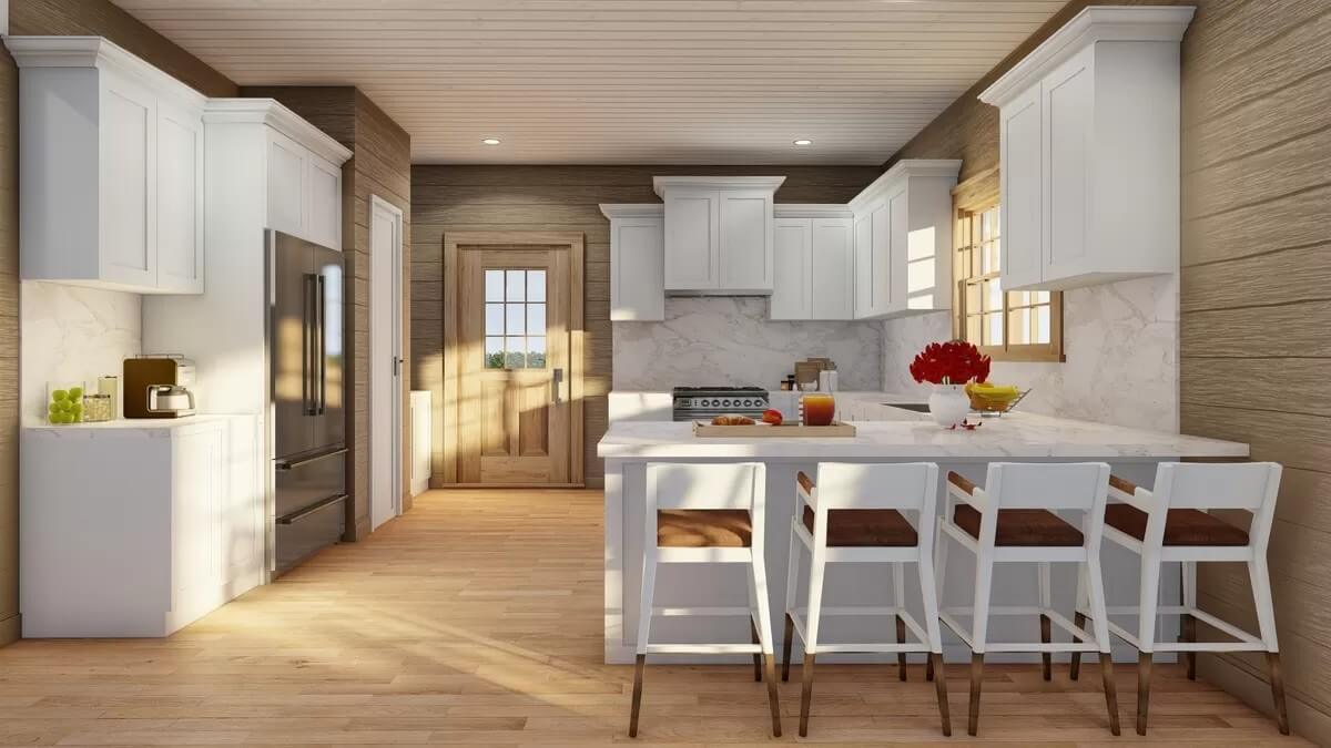 Kitchen with white cabinetry, modern appliances, and a peninsula with bar seating.