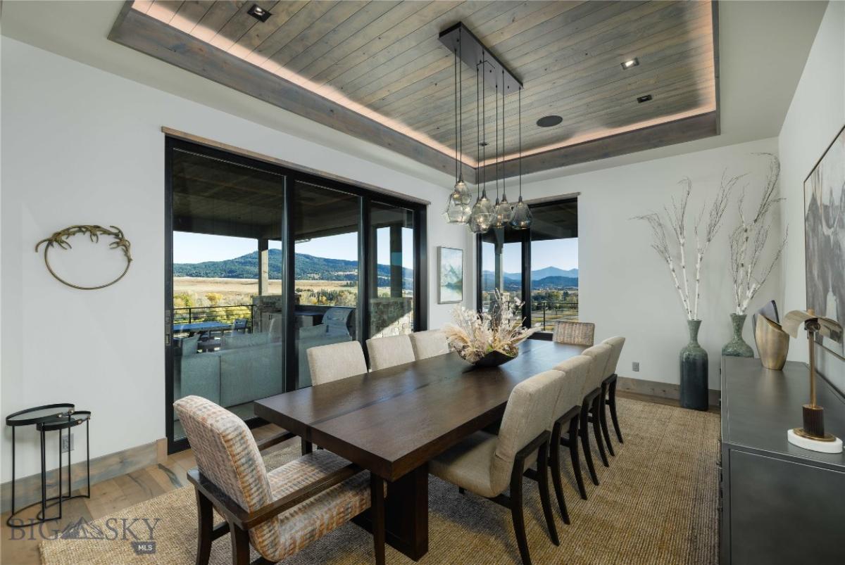 Dining room with custom lights and expansive sliding glass doors.