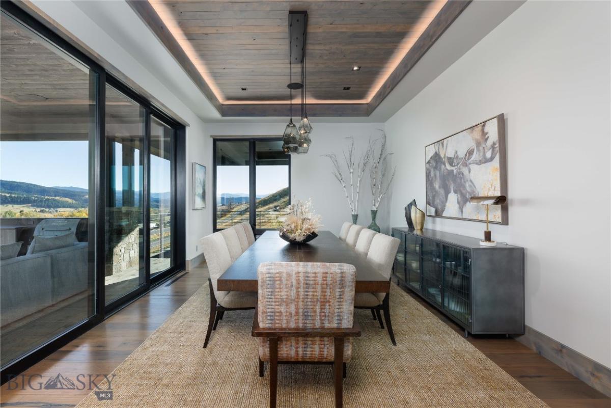 Dining room with custom lights and expansive sliding glass doors.