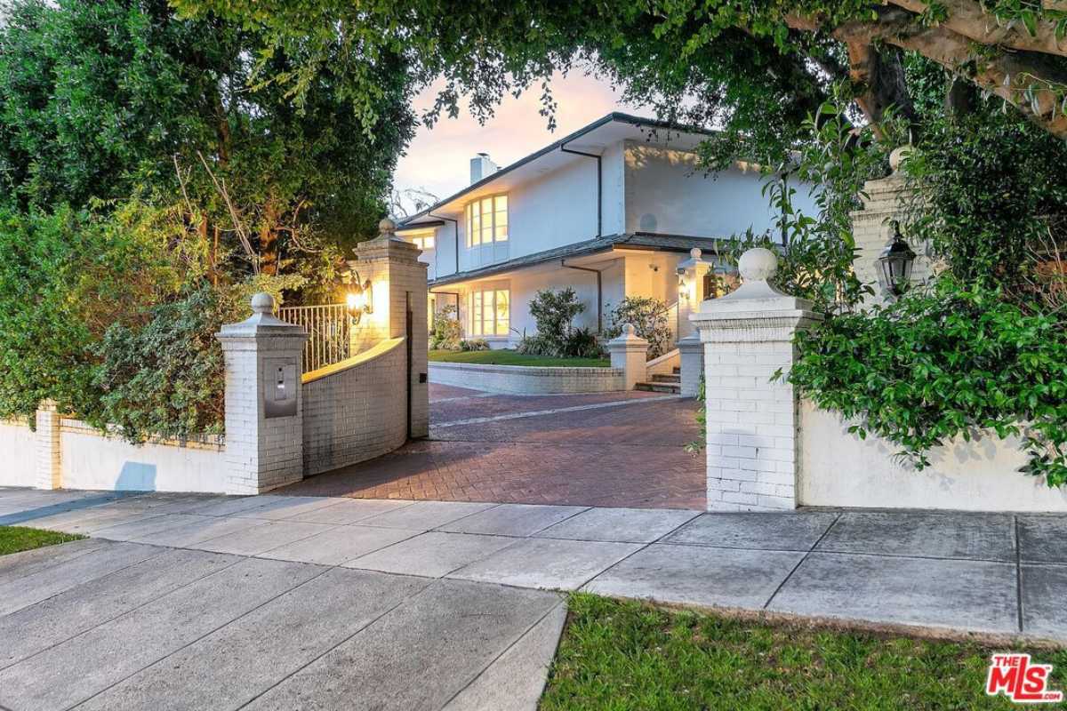 A front entry embraced by trees.