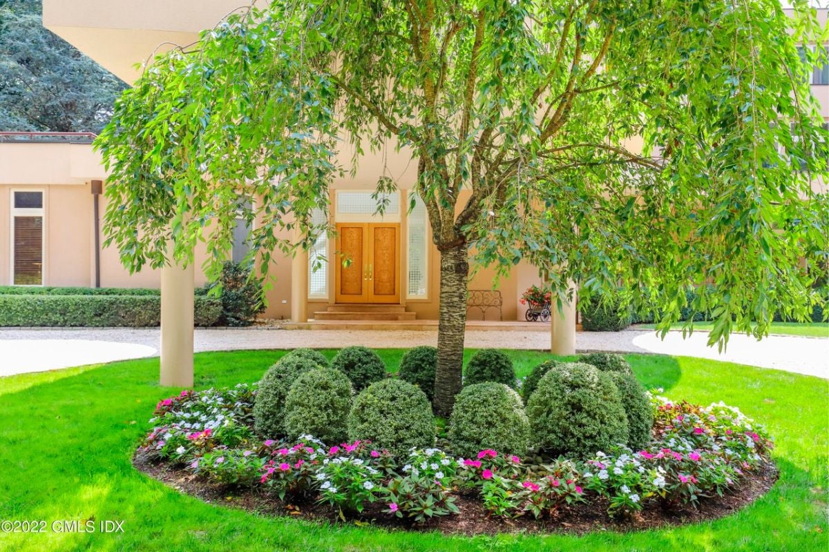 A courtyard adorned with grass, plants, and trees.