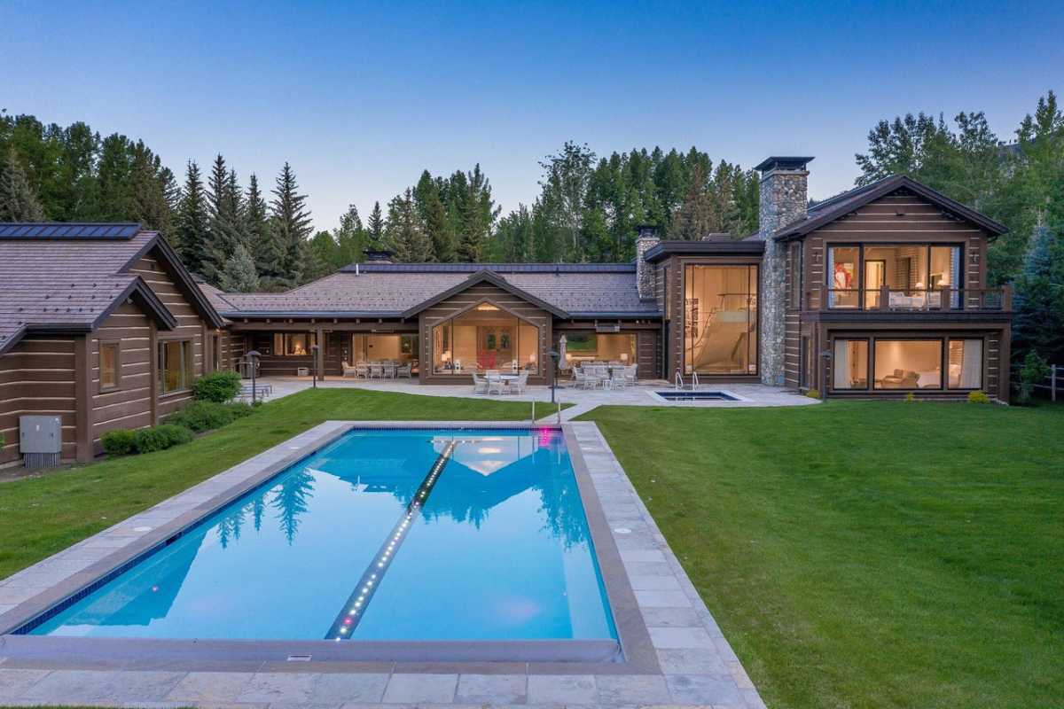 A swimming pool surrounded by green grass.