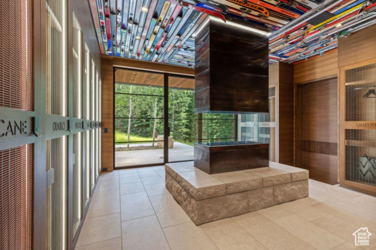 A foyer with tiled floor, aquarium, and colorful ceiling.