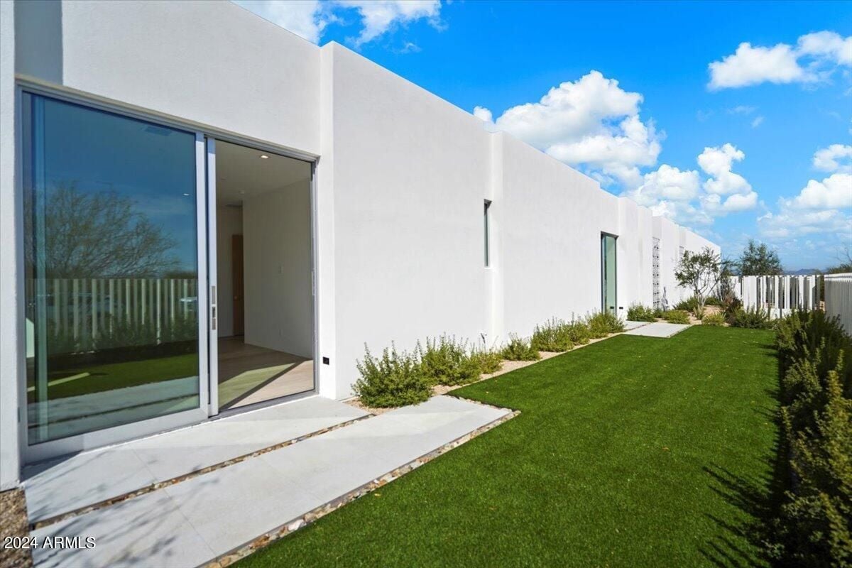 A backyard with grass and plants.
