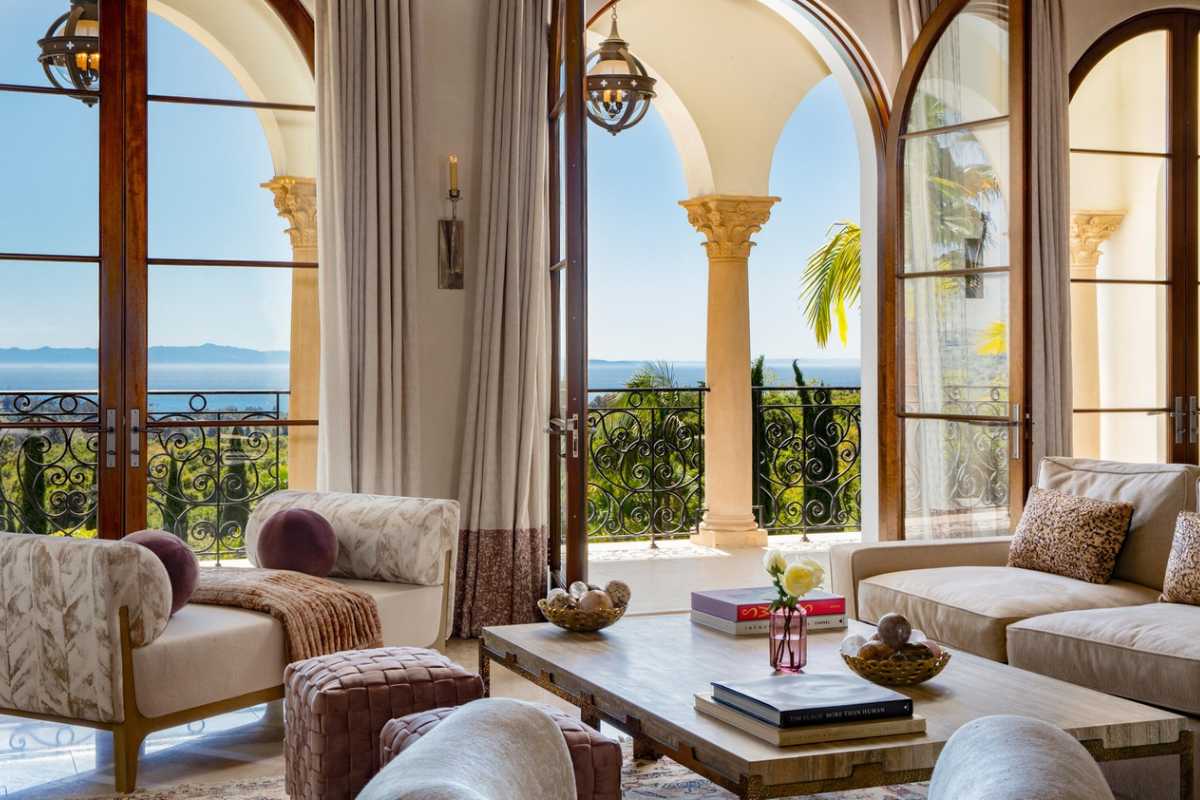 A living room with a coffee table surrounded by couches.