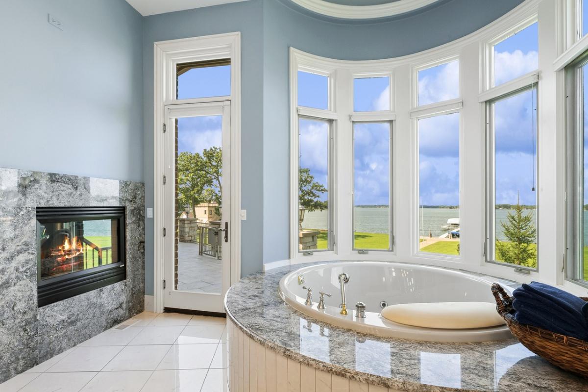 Bathroom with soaking tub and a fireplace.