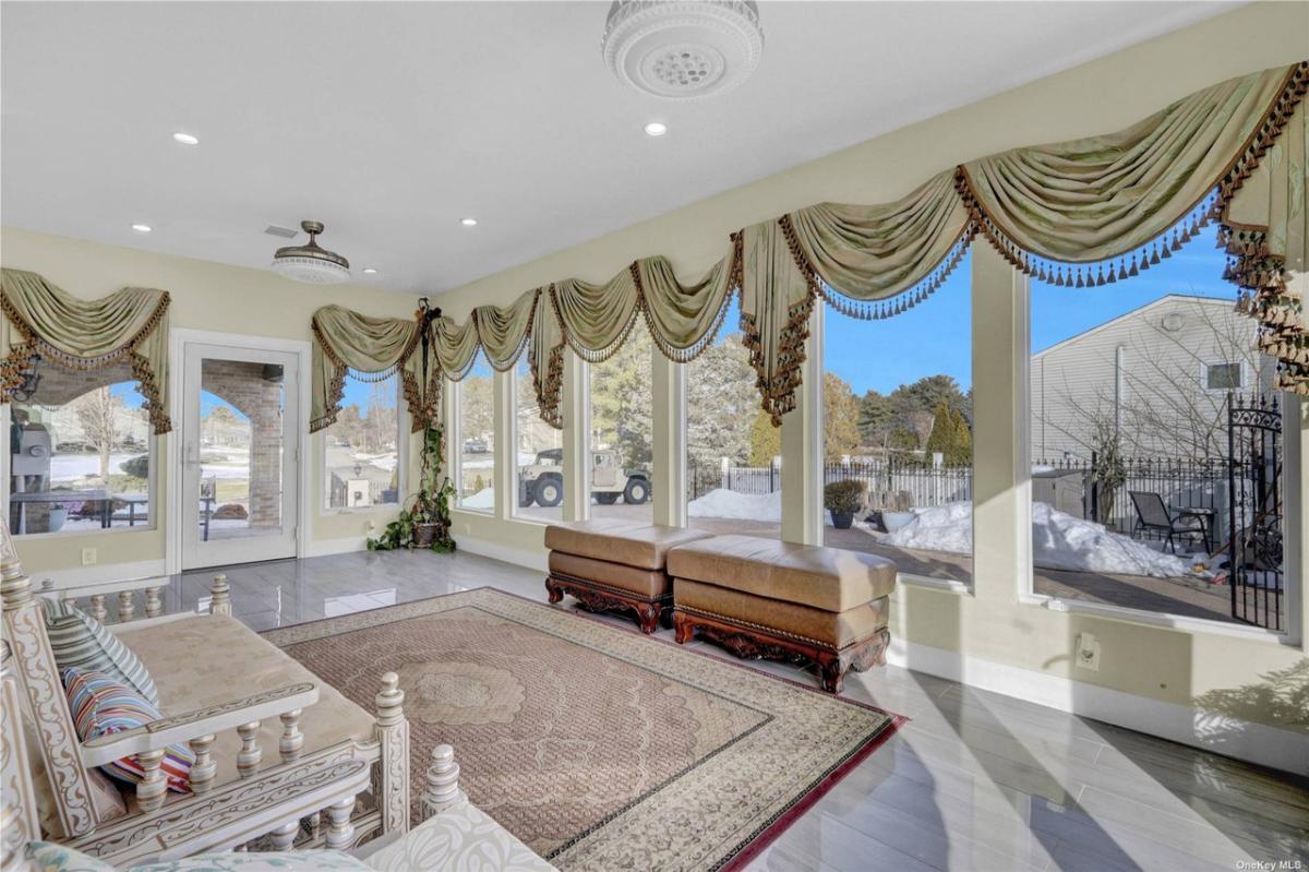 Sun room with tile flooring.