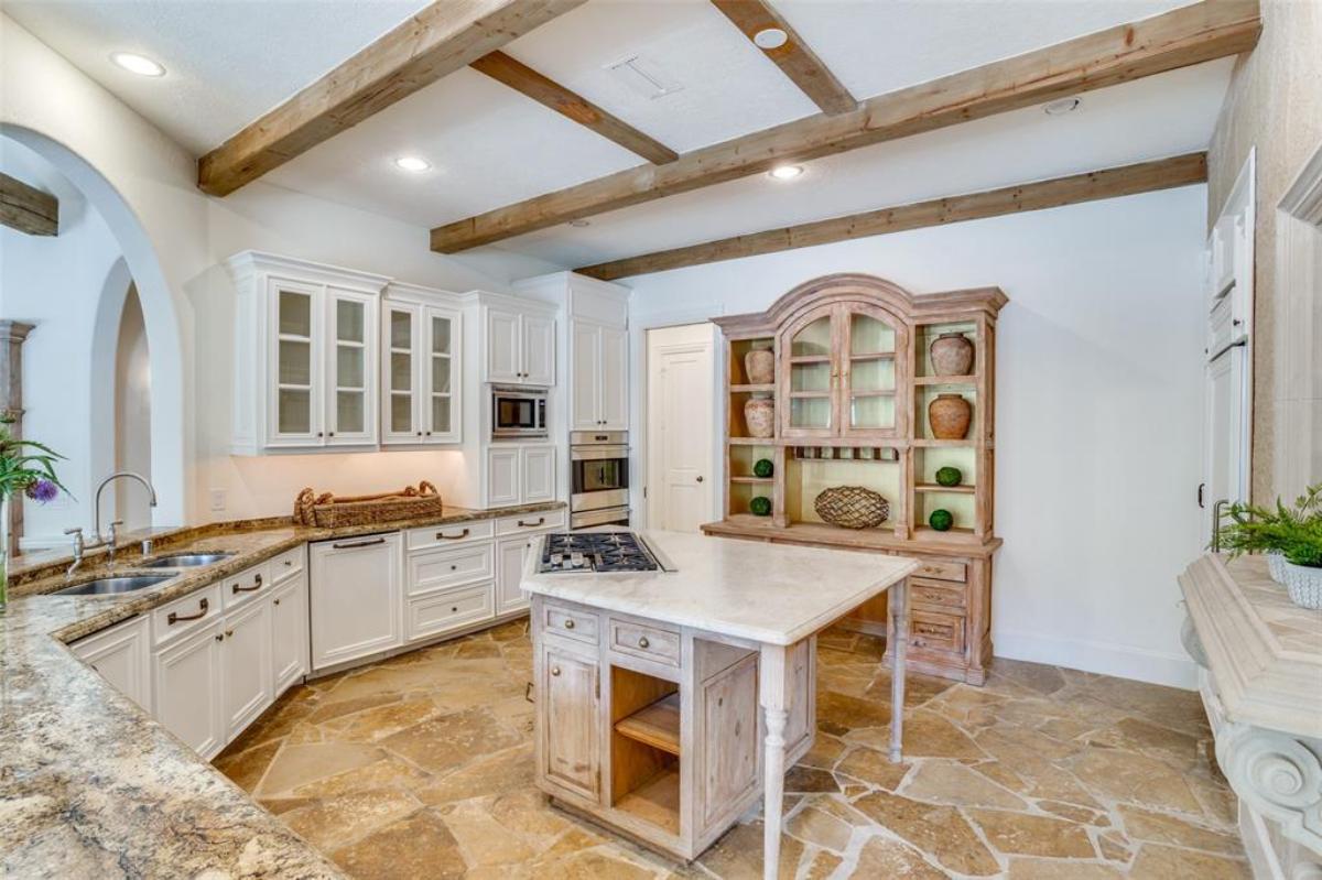 Kitchen with granite countertops and open beam ceiling.