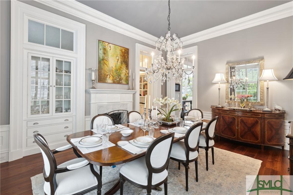 Dining room with a chandelier and wood flooring.