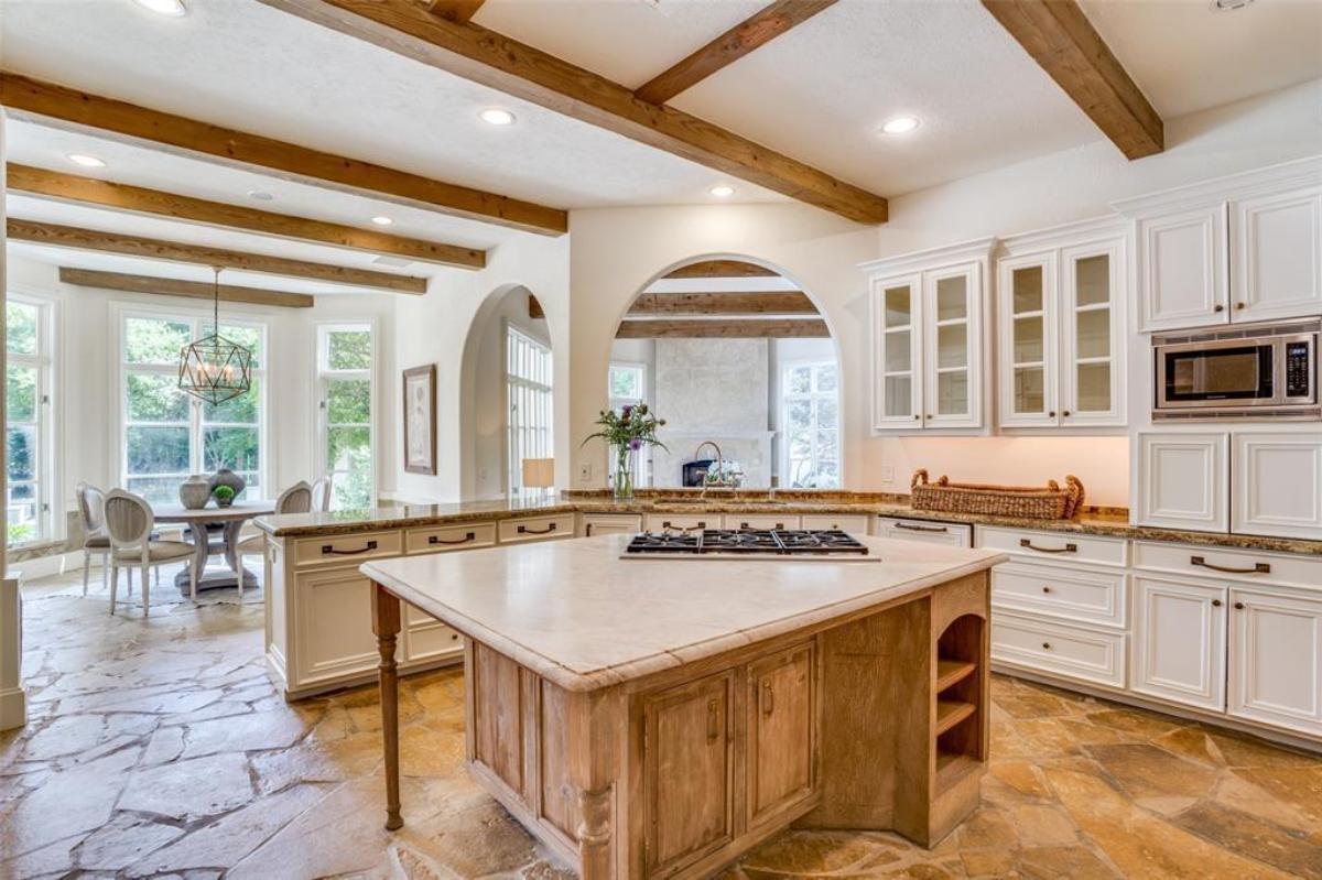 Kitchen with granite countertops and open beam ceiling.