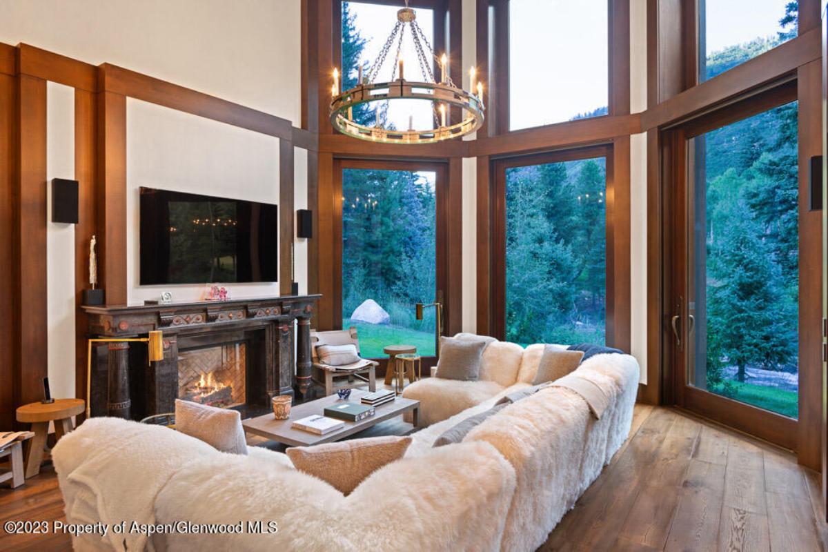 Family room with couches, fireplace and a TV.