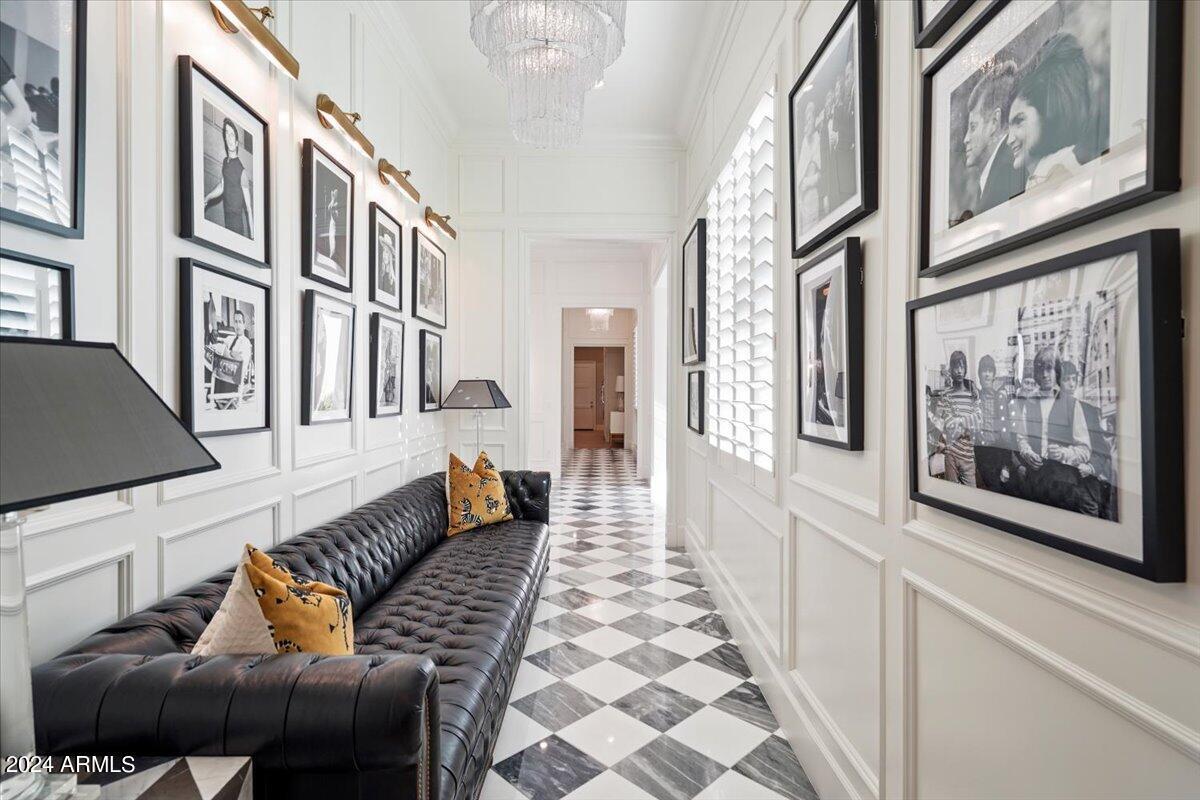 Hallway with a large couch and tile flooring.