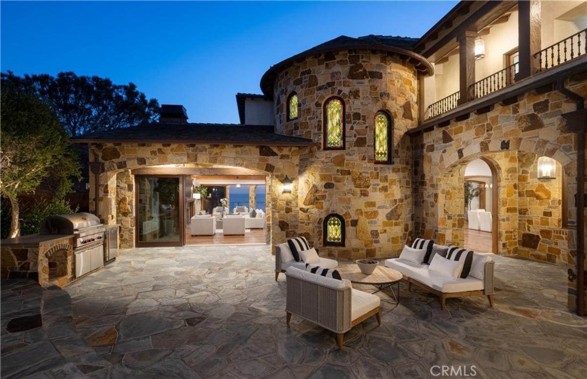 Patio with a table, couch and chairs.