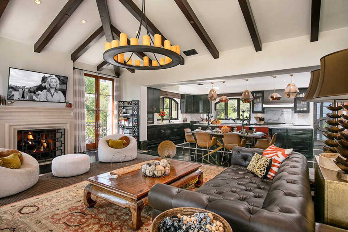 A great room with a beamed ceiling, living space, a dining area, and a kitchen.