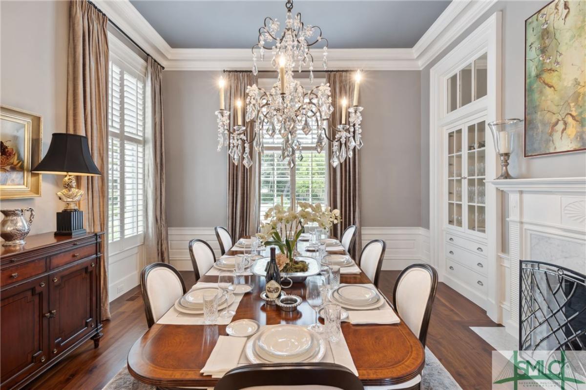 Dining room with a chandelier and wood flooring.