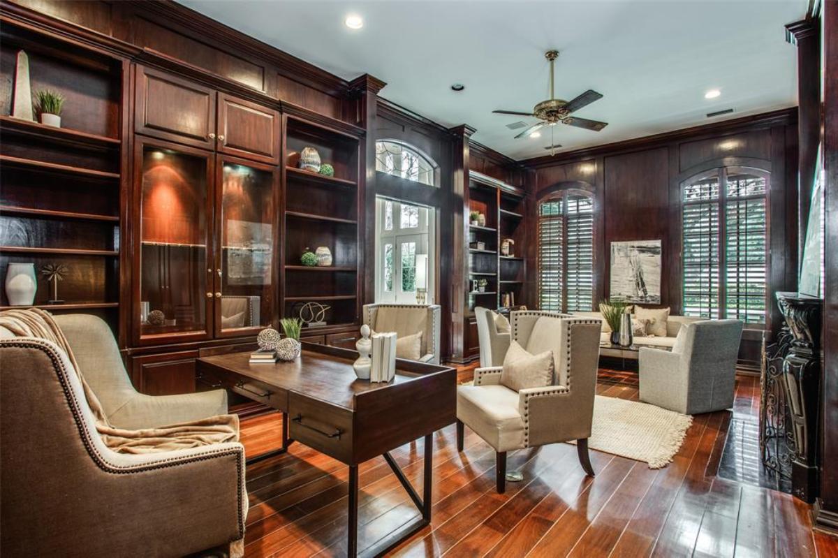 Home office with wood flooring and custom cabinetry.