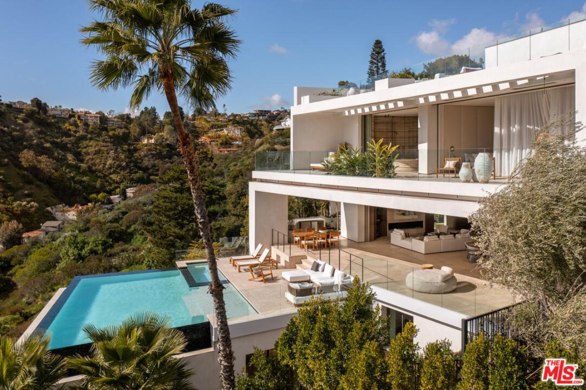 Aerial rear view of the mansion with a pool.
